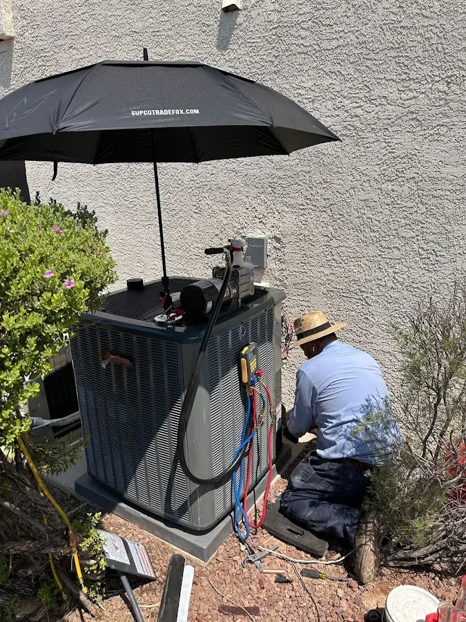 HVAC technician performing outdoor AC maintenance in Hillsborough
